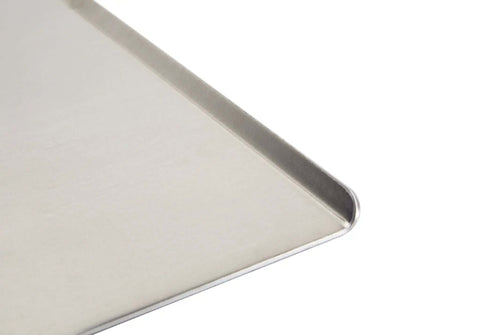 Close-up of Wear-Ever Aluminum Cookie Sheet Pan 17 by 14 Inches, showcasing the heavy gauge aluminum and smooth curved edge.