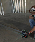 Boss Class 12V Max Three Plane Green Beam Laser Level in use for precise alignment on construction site