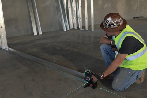 Boss Class 12V Max Three Plane Green Beam Laser Level in use for precise alignment on construction site