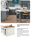 Modern kitchen with gray cabinets and a central island, featuring a dining area with bar stools and decorative plants.
