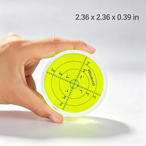 Magnetic Round Bubble Level Tool Bullseye Inclinometer Machinist held in hand, displaying yellow measurement grid.
