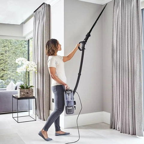 Person using Five Pack 1.25 Inch Vacuum Extension Wands With 1.38 Inch To 1.25 Inch Hose Adapter to clean ceiling corners.