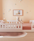 Twin Size Montessori Floor Bed With Safe Guardrails For Toddlers, White Wood Frame, low to the ground, with teddy bears on bed