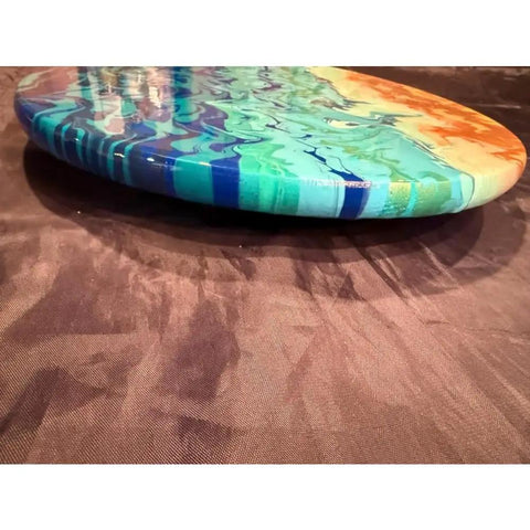 Close-up of a vibrant blue and orange 15-inch hand painted lazy Susan that spins 360 degrees for dining tables and kitchen counters.