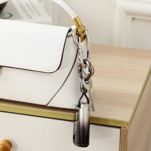 Close-up of Y2K Style Irregular Carabiner Keychain Clip For Heavy Duty Multi Use Hook on a white purse handle.