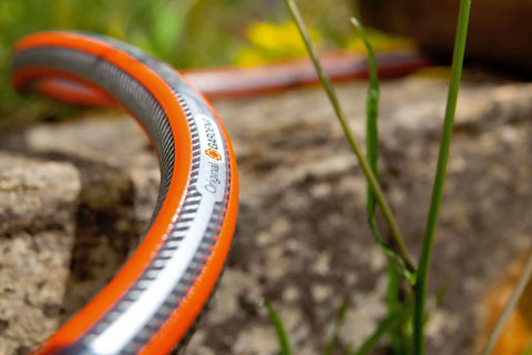 Heavy Duty Three Quarter Inch Garden Hose, 25 Meter Length, 59 Feet, Flexible No Kink Water Hose coiled on garden rock