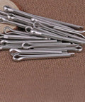 Heavy Duty Split Pin Assortment Kit With 556 Rust Resistant Cotter Pins In Various Sizes for industrial applications on fabric.