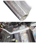 Heavy-Duty Self-Wrap Aluminum Heat Shield Sleeve With Side Entry For Hoses Wiring Harnesses And Cables In Automotive Exhaust, 39 Inch Length, Temperature Range -40C To 150C, Oil Resistant, 25 Percent Overlap, High Temp Sleeve wrapped around automotive cables