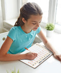 Girl using Dry Erase Multiplication Board 9x12 Inch Double Sided Times Table Whiteboard With Easy Wipe Coating in classroom