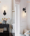 SANTOSTOCK Black Wall Sconces Set of Two, Hardwired Bathroom Vanity Sconces Wall Lighting with Clear Glass Shade, modern design on walls.