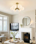 Brushed Gold Sputnik Flush Mount Ceiling Light With Six Milk Glass Globes in living room interior