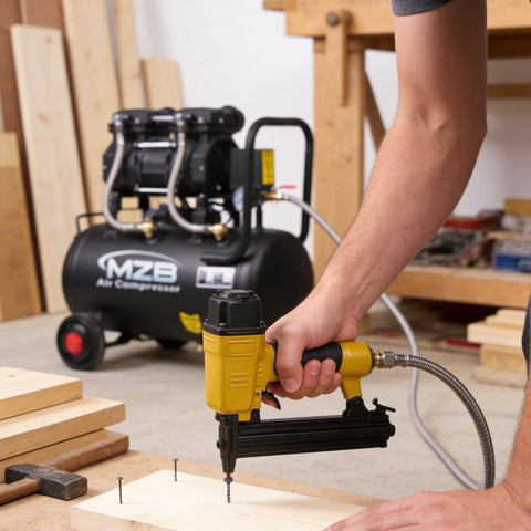 Person using nail gun connected to 6.4 Gallon Ultra Quiet Air Compressor With Steel Tank And Wheels Oil Free 70 Decibels 110V