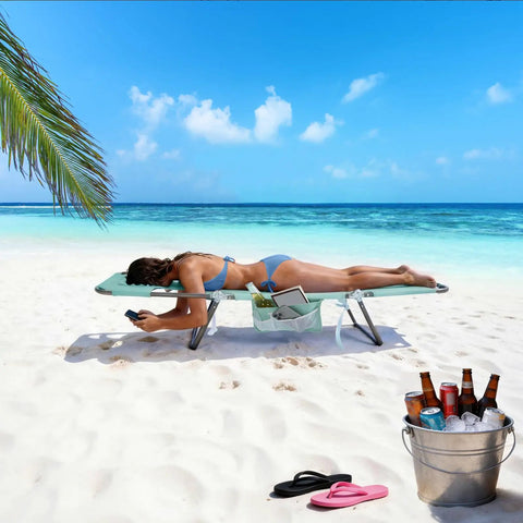 Woman relaxing on Reclining Beach Lounge Chair With Flat Lay Sunbathing Position, Folding Camping Cot With Backpack Straps, Portable Outdoor Chair For Beach Or Picnic, Lawn, Side Pockets For Drinks And Gear on sandy beach with ocean view.