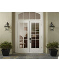 Burlington Three Light Large Wall Lantern With Clear Beveled Glass In Polished Nickel And Antique Bronze Finish on entryway
