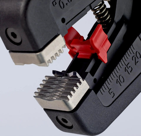 Close-up of Precistrip16 Automatic Insulation Stripper showing semi-circular gripped jaws and adjustable length stop in action.