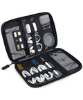Travel Ready Electronics Organizer Case for Cords and Tech Gear, containing cables, adapters, and SD cards, open view