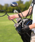 Golfer using U Shaped Golf Club Holder Set Two Pack That Keeps Your Clubs Clean Dry And Visible Detachable Metal Stand Durable Golf Club Rack For Easy Carry On The Course And Protect Your Bag On The Go on the course.