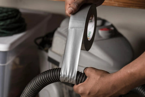 Heavy Duty Silver Duct Tape Roll 1.88 Inch By 45 Yard 1 Pack being used for repair on a plastic vacuum hose