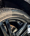 Perl Coat Plastic And Rubber Protectant for Cars revives tire and rim with UV shield, visible next to 500 mL bottle.