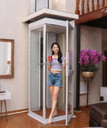 Through Ceiling Compact Home Elevator Shaftless Design For Space Saving Living With Zero Wall Damage Heritage Approved, Customizable Configurations For Homes Farms And Land Projects, Easy Install And Quiet Deck Lift For Modern Homes, glass shaftless lift in a living room