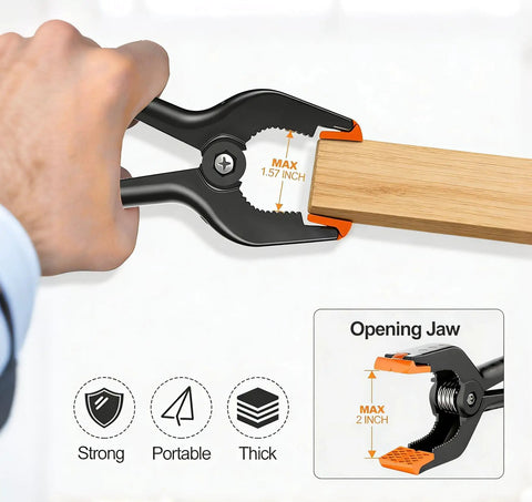 Hand using 12 Pack Heavy Duty 4.5 Inch Spring Clamps With Grip Jaw Pads For Photography Studio Backdrops And Carpentry Projects, durable