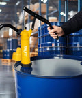 TALFIT lever-action barrel pump installed on a blue 55-gallon drum; yellow pump with black lever and spout