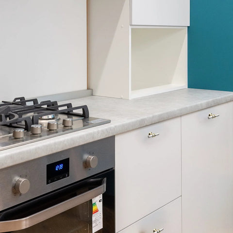 Modern kitchen with white cabinets featuring 10 Pack Cabinet Knobs In Brushed Nickel And Gold Finishes, single hole design installed.