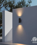 Dual Head Outdoor Porch Light Wall Sconce 4 Pack Matte Black with aluminum rectangular tube on wall, glowing at night