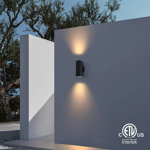 Dual Head Outdoor Porch Light Wall Sconce 4 Pack Matte Black with aluminum rectangular tube on wall, glowing at night