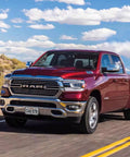 Ram 1500 DT truck on road, showcasing front view with curved bumper suitable for Front License Plate Frame For 2019 To 2024 Ram 1500 DT.