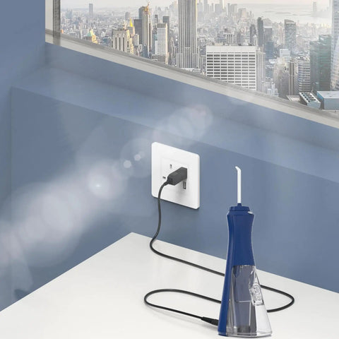 Replacement Water Flosser Charger For Cordless Models WP360 WP360C WP360W WP440 WP400 WP440C WP450 WP462 WP462W And WF Series USB Charging Cable 5ft Power Adapter connected to wall socket with blue water flosser.