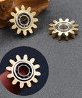 Close-up of brass gear linkage for Brass Gears Linkage Fidget Spinner With Aluminum Frame And 13 Bearings Delivers Smooth Long Spin Time Of 2 To 4 Minutes For ADHD Focus Meditation And Breaking Bad Habits Black Finish 4 Inch EDC Spinner Weighs 141.7 Grams