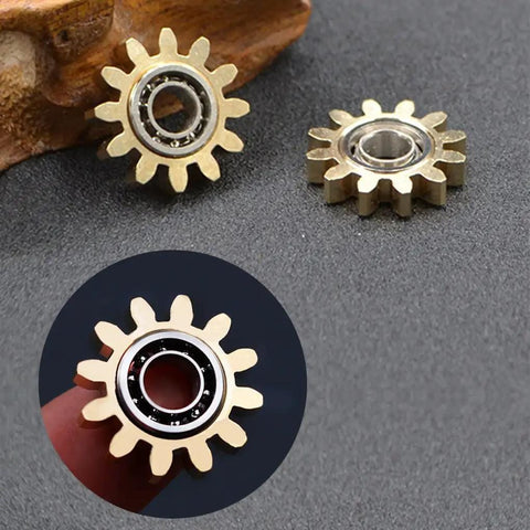 Close-up of brass gear linkage for Brass Gears Linkage Fidget Spinner With Aluminum Frame And 13 Bearings Delivers Smooth Long Spin Time Of 2 To 4 Minutes For ADHD Focus Meditation And Breaking Bad Habits Black Finish 4 Inch EDC Spinner Weighs 141.7 Grams
