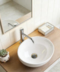 NUESTRA VIDA Overhead Sink Oval Ceramic 16.1 * 13 * 5.5 IN on wooden countertop with faucet and decorative items.