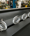 16 Pack Shouldered Eye Bolts With Nuts Half Inch By Six Inch Hot Dip Galvanized Heavy Duty Industrial Lifting Anchoring Hanging For Real World Builds Tough As Nails Construction And DIY Projects. Close-up of galvanized shouldered eye bolts on a bench
