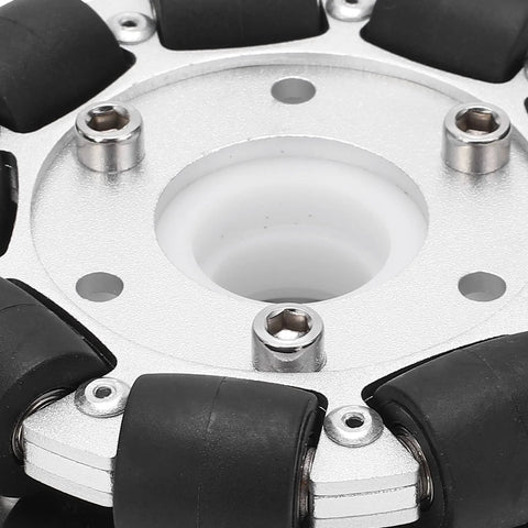 Close-up of 100mm aluminum omni wheel hub with black rubber rollers on a silver mounting plate