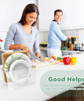 Space Saving Acrylic Paper Plate Dispenser For 5 To 12 Inch Plates on a kitchen counter with people cooking in background.