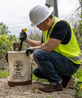 Worker using Heavy Duty Canvas Tool Bucket With No 4 Canvas And Leather Bottom, 17 Inch High By 12 Inch Diameter, 100 Pound Load Rating