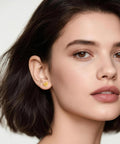 Close-up of a model wearing Implant Grade F136 Titanium Cubic Zirconia Stud Earrings Secure Screw Back, heart-shaped design.