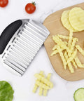 Side view of stainless steel potato crinkle cutter with black handle; large wavy fry cutter for potatoes and vegetables.