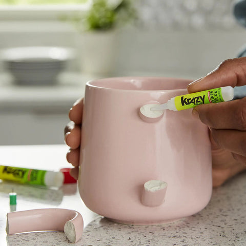 Person using All Purpose Glue With Precision Tip For Easy Home Repairs 2 G Bottles 2 Count Bonds Plastic Ceramic Wood Rubber Metal Leather And More Stay Fresh Container For Longevity to fix a ceramic mug handle.