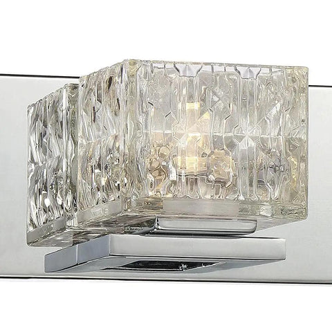Close-up of 3 Light Sleek Chrome Integrated LED Vanity Light With Clear Cube Glass, featuring a modern chrome backplate