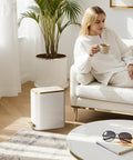 Compact Bathroom Trash Can With Lid And Soft Close, 5 Liter Stainless Steel Slim Waste Basket, White and Gold Trim, beside sofa