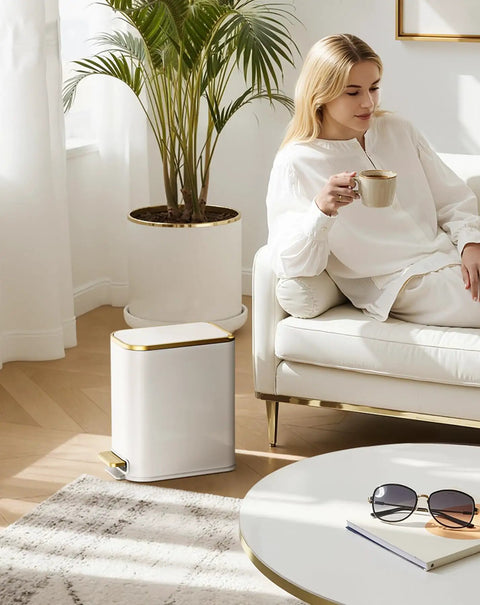 Compact Bathroom Trash Can With Lid And Soft Close, 5 Liter Stainless Steel Slim Waste Basket, White and Gold Trim, beside sofa