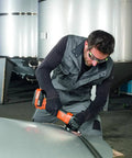 Pro Rig Cordless Angle Grinder With 125 Mm Disc And 18 Volt Brushless Motor Cranks Out 1100 Watts Of Torque In a user's hand on metal.