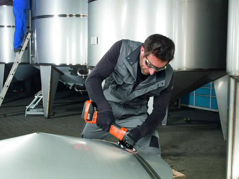 Pro Rig Cordless Angle Grinder With 125 Mm Disc And 18 Volt Brushless Motor Cranks Out 1100 Watts Of Torque In a user's hand on metal.