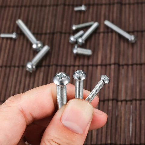 Close-up of carbon steel screws from 720 Piece Nuts And Bolts Kit With Carbon Steel M3 M4 M5 Screws Nuts And Washers In Cross Pan Head Machine Screws Set Heavy Duty Storage Case For DIY Projects And Garage Fixes.