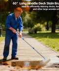 Man using Long Handle Deck Stain Brush With 64 Inch Adjustable Shaft And 8 Inch Paint Brush Included for oil staining on wood floor