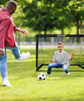 Child playing with Two Pack 4x3ft Pop Up Kids Soccer Goals For Backyard Portable Soccer Nets Includes Ball Ladder Cones And Targets