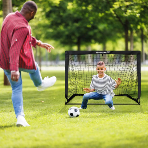 Child playing with Two Pack 4x3ft Pop Up Kids Soccer Goals For Backyard Portable Soccer Nets Includes Ball Ladder Cones And Targets